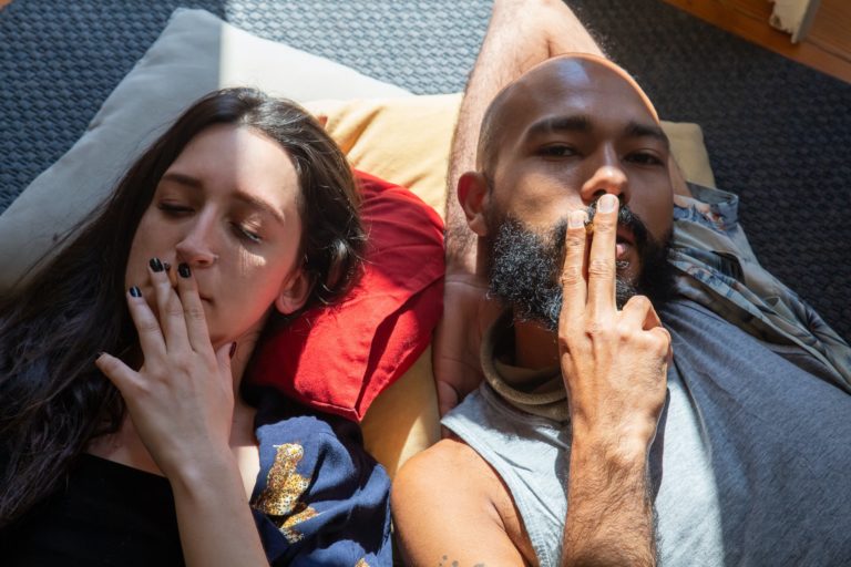 A Couple Smoking Joints while Lying on the Floor | The Heirloom Collective